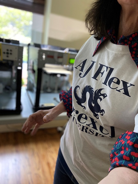 Woman wearing an AJ Flex t shirt while printing 3D face shields